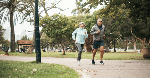 Older couple jogging in the park