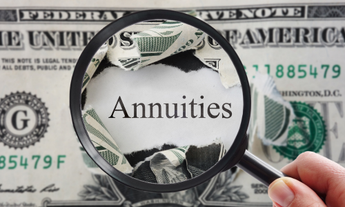 Magnifying glass hovering over a one dollar bill magnifying the word "annuities."